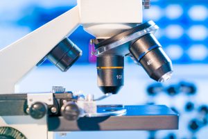 Microscope and model of molecule in laboratory